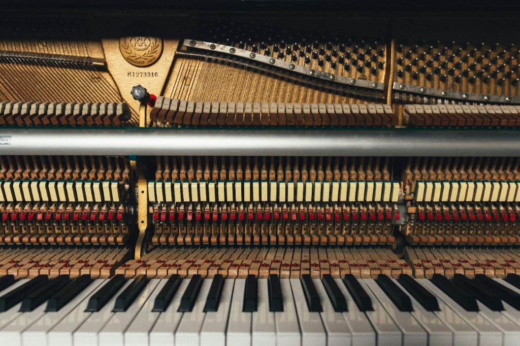 Piano interior with keys, hammers, and strings